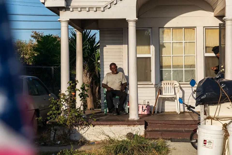 Photo of a man sitting on his porch