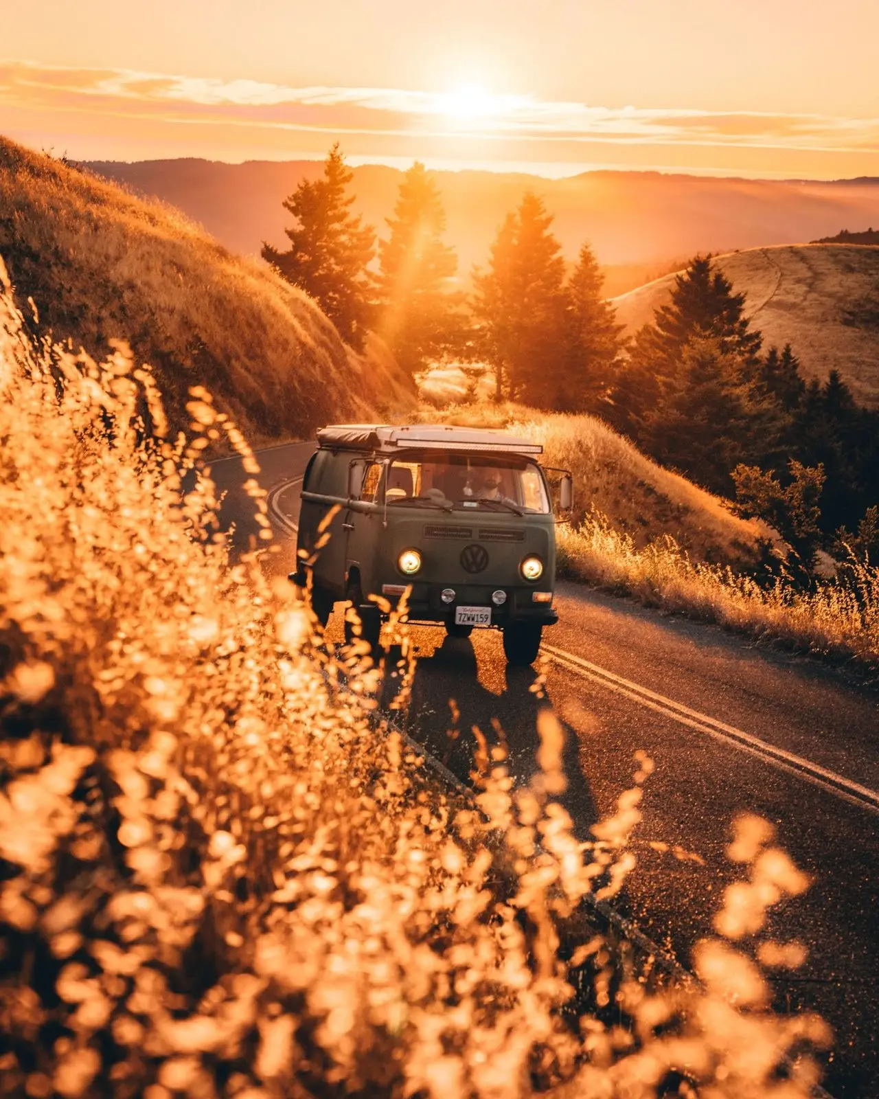 An old VW van ascends a curvy road during the golden hour at Mount Tamalpais just north of San Francisco, California.